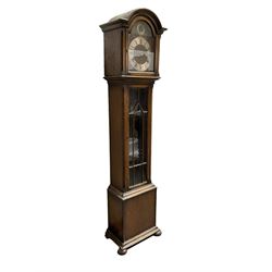 English - 20th century oak cased 8-day chiming granddaughter clock with a break arch pediment, fully glazed trunk door on a rectangular plinth raised on bun feet, three train chain driven movement with Westminster, Whittington and St Michael chimes on the quarters and hours, movement with 12 gong rods. With three brass cased weights, no pendulum.