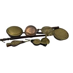 Two brass warming pans, copper warming pan, brass kettle stand and two pairs of bellows