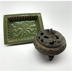 Oriental bronze koro with pierced dragon cover and seal mark to base D12cm and a green glazed rectangular shallow dish with raised leaf decoration 18cm x 14cm