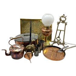 Victorian copper and brass oil lamp, converted to electricity, set of three milk measures with brass handles, large copper pan and cover, large embossed brass tray, cast brass easel and other metalware 