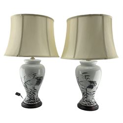 Pair of Chinese porcelain table lamps, each of inverted baluster form, decorated with wading Herons amongst reeds against a plain ground, raised upon circular hardwood base, H68cm including shade