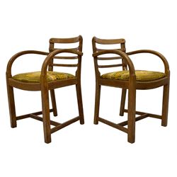 Heals of London - circa. 1930s set of four oak dining chairs, curved ladder back over curved arms, padded drop-in seat cushions upholstered in Irmgard Krebs (for Heals) ‘Cherry Orchard’ fabric, on square supports united by H stretchers