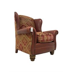 Tetrad - 'Eastwood' wingback armchair, upholstered in buffalo hide leather with studwork, with Kilim chenille loose cushions, raised on turned feet
