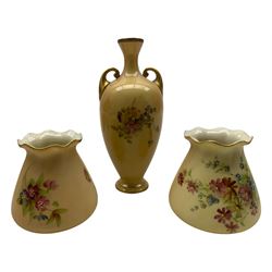 Pair of Royal Worcester blush ivory porcelain posy vases, with floral decoration shape no. 957, H9cm; Royal Worcester blush ivory porcelain twin handled vase of tapered form with gilt handles and rim and floral decoration, numbered 2871, H17.5cm