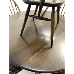 Ercol dark elm drop leaf dining table,  oval top raised on four moulded and splayed square supports united by 'X' stretcher, together with a set of five (4+1) Ercol dining chairs chair 
