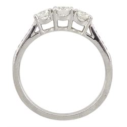 Platinum three stone round brilliant cut diamond ring, with diamond set shoulders, hallmarked, total diamond weight approx 0.65 carat