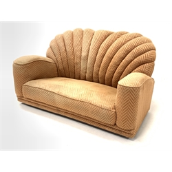 Early 20th century Art Deco shell back two seat sofa, upholstered in salmon herringbone fabric, raised on metal castors, W150cm, H82cm, D95cm