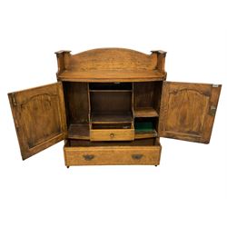 Early 20th century oak wall hanging cabinet, raised back, fitted with two panelled cupboard doors enclosing fitted interior with pigeonholes and small drawer, over single drawer