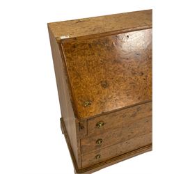 Figured walnut bureau, the fall front enclosing pigeon holes, fitted with three drawers, on bracket feet