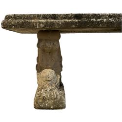 Three-piece weathered cast stone garden bench, rectangular top on recumbent lion end supports 
