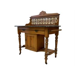 Late Victorian walnut framed washstand, raised back with scallop pediment over five tiles with flower head decoration, the rectangular marble top over single drawer and small cupboard, raised on ring turned supports terminating in ceramic castors