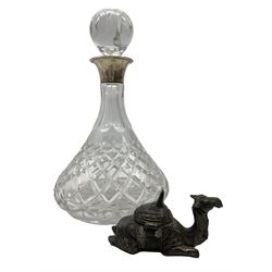 Early 20th century cast metal inkwell in the form of a seated camel, L12cm x H6cm together with a modern cut glass decanter with silver collar by A Edward Jones Ltd, 1993 H29cm