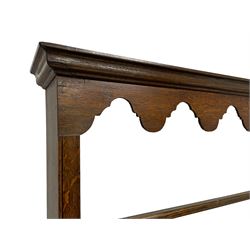 George III oak Yorkshire dresser and rack, the moulded cornice over a fretwork frieze and three-tier plate rack, the base fitted with four central graduating drawers flanked by two drawers over single panelled cupboard doors, the ends fitted with two small drawers over applied moulded panels, raised on stile feet