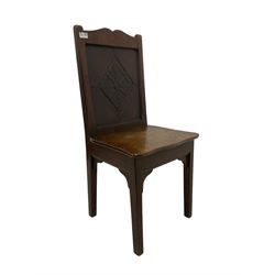 Late 19th century oak hall chair, the panel back carved with foliate lozenge (W43cm D39cm H90cm); and a Victorian footstool, seat upholstered in deep crimson velvet, raised on cabriole feet (W39cm H19cm)