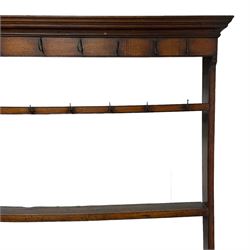 18th century oak dresser, projecting moulded cornice over two rows of wrought metal hooks and two tiers, the base with rectangular top over three cock-beaded drawers, four turned front pillar supports on boarded base, turned feet