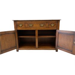 Oak sideboard, the projecting rectangular top over one long and two short drawers over two cupboard doors opening to reveal one adjustable shelf, raised on stile supports 