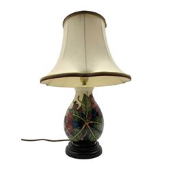Moorcroft table lamp decorated in the 'Simeon' pattern by Philip Gibson, of baluster form on turned ebonised base, with shade, H45cm including shade 
