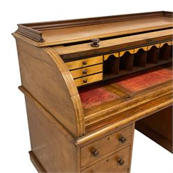 Victorian mahogany roll-top knee-hole desk, roll-top enclosing fitted interior with maple correspondence drawers and pigeonholes, sliding writing surface with adjustable central panel, fitted with six graduating drawers