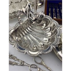 Silver plated shell shape dish by John Round with cherub handle W20cm, plated oval six bottle cruet, glass claret jug with plated cover , ice bucket and other plated items
