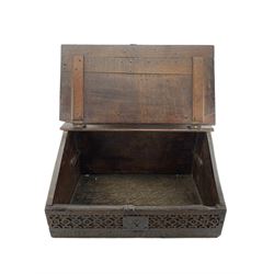 17th century oak bible box, the rectangular hinged lid carved with central cross over initials 'OB', the front carved with strapwork with central wrought metal lock, the sides decorated with carved lunettes and stylised acanthus leaves