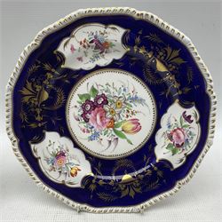 Pair of early 19th century Derby plates, hand painted with floral sprays on cobalt blue and gilt ground within shaped borders, D26cm, together with another Derby shaped plate, hand painted with floral sprigs (3)