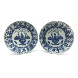 Pair of 18th century Delft blue and white chargers, centrally painted with a vase of flowers, the borders with hatched panels divided by foliage D31cm 