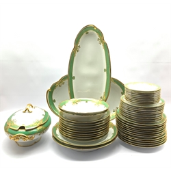 Dresden dinner service decorated with a green and gilt border pattern comprising twelve dinner plates, nine dessert plates, nine soup bowls, nine side plates, soup tureen with cover and stand, two open serving dishes, two circular platters, sauce boat and stand and a meat plate (47) 