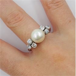 18ct white gold pearl ring, set with three round brilliant cut diamonds either side, approximate total diamond weight 0.60 carat 