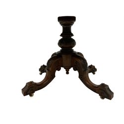 Mid-to late century walnut loo table, oval top with moulded edge and quarter match finish, fluted and turned pedestal with foliate carving over swept cabriole supports with scrolling and flower head decoration on ceramic castors 