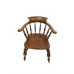 Smokers bow chair, the spindle back over elm seat, raised on turned supports united by a stretcher 