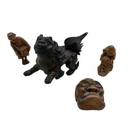 Small Japanese bronze lion with one raised paw L8cm and three 19th century carved wood netsukes