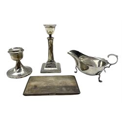 Engine turned silver cigarette case Birmingham 1968, silver sauce boat Sheffield 1916, silver candlestick H15cm and a dressing table candlestick, weighable silver 11.2oz