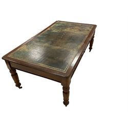 Late 19th century mahogany library writing or correspondence table, rectangular top with leather inset writing surface and moulded edge, fitted with three cockbeaded drawers to either side, raised on turned tapering supports terminating in brass and ceramic castors