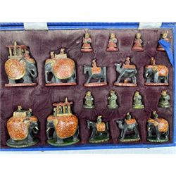 20th Century Indian carved wooden, painted and gilt figural chess set in velvet case