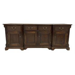 20th century oak sideboard, the breakfront top over four drawers and four cupboards, raised on bracket supports 