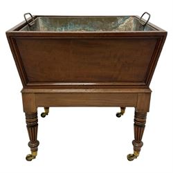 Possibly Gillows - George III mahogany wine cooler, tapering rectangular form with figured front and applied mouldings, the base with moulded upper edge on turned and reed carved supports, brass castors, with metal interior lining