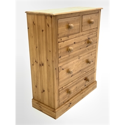 Traditional polished pine chest, fitted with two short and three long drawers, raised on skirted base 