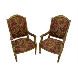 Pair Louis XVI design gilt framed armchairs, the cresting rail moulded with flower heads and roses, the frame moulded with ribbon fold border and beading, scrolled arm terminals decorated with acanthus leaves, raised on fluted tapering supports, upholstered in floral fuschia fabric with sprung seat