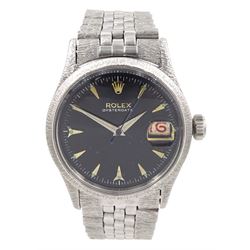 Rolex Oyster Perpetual Date gentleman's stainless steel automatic wristwatch, circa 1954,  21 jewels, Ref. 6518, Cal. 1000, Serial No. 33738, black dial with applied sharks tooth markers with luminous dots and hands, the movement numbered 475052, bark effect bezel and lugs, on original Jubilee polished and bark effect bracelet, with fold-over clasp engraved U.S.A