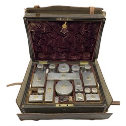 Extensive early Victorian gentleman's travelling toilet service fitted with silver and silver mounted glass containers each with a gilt insert with the Feversham crest, the lower tray with mother of pearl items including razors, tongue scraper, manicure implements etc in a brass inlaid coromandel box with the Feversham crest London 1837/8 Makers Mark T.D possibly Thomas Diller together with three later silver mounted glass jars, in an outer leather case inscribed 'W.D. First Life Guards' 40cm x 30cm x 19cm  Provenance:  1st Baron Feversham