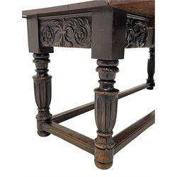 17th to 18th century oak refectory table, rectangular fold-over top over the frieze rail carved with a central cartouche with scrolling foliate and berries, sliding front rests with acanthus carved corbel mounts, turned fluted supports with foliate scroll carving, joined by moulded stretcher rails, foliage scroll and floral carved side frieze rails and plain back, the back rail with plain sliding rests