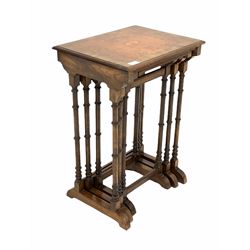 20th century figured walnut nest of three tables, the cross banded top inlaid with  with E.R.II. roundel, each table raised on slender ring turned supports with sledge feet W46cm