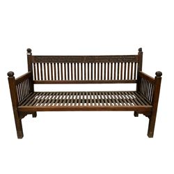 Early to mid-20th century teak garden bench, slatted back and seat, raised on square supports with shaped spandrels