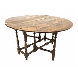 18th century oak drop leaf table, the oval top raised on turned and block supports with gate leg action, 125cm x 138m, H68cm