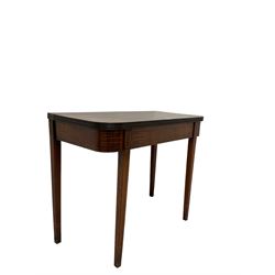 Edwardian mahogany tea table, the fold over top over frieze with satinwood string inlay, raised on square tapering supports 