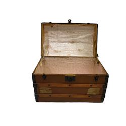 Early 20th century travelling trunk, hinged dome top with iron fittings, wood bound, on castors