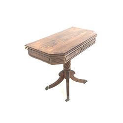 Regency mahogany tea table, the cross banded and string inlaid fold over revolving top with canted corners over frieze with applied moulding, raised on a spiral turned column and four leaf moulded splayed supports with brass paw cup castors, W92cm