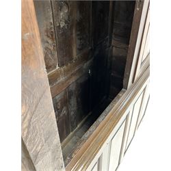 18th century oak press, projecting cornice over two panelled doors with brass fixtures, four panelled base raised on stile supports, the interior converted for hanging W137cm, H187cm, D52cm