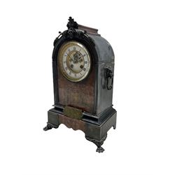 A late 19th century Belgium slate mantle clock with carved applied decoration to the arched top, on a shaped rectangular plinth raised on four paw feet, with a centre panel in contrasting pink marble with incised decoration, two part contrasting white enamel dial with Roman numerals and minute markers, steel spade hands and visible Brocot escapement, dial within a cast brass bezel with a flat bevelled glass, eight-day Parisian striking movement, striking the hours and half hours on a bell.  With pendulum. 

