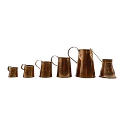 Set of five 19th century copper tankard measures comprising 1/2 Gallon, Quart, Pint, 1/2  Pint and Gill H22cm (max) together with a later copper measure with brass handle 